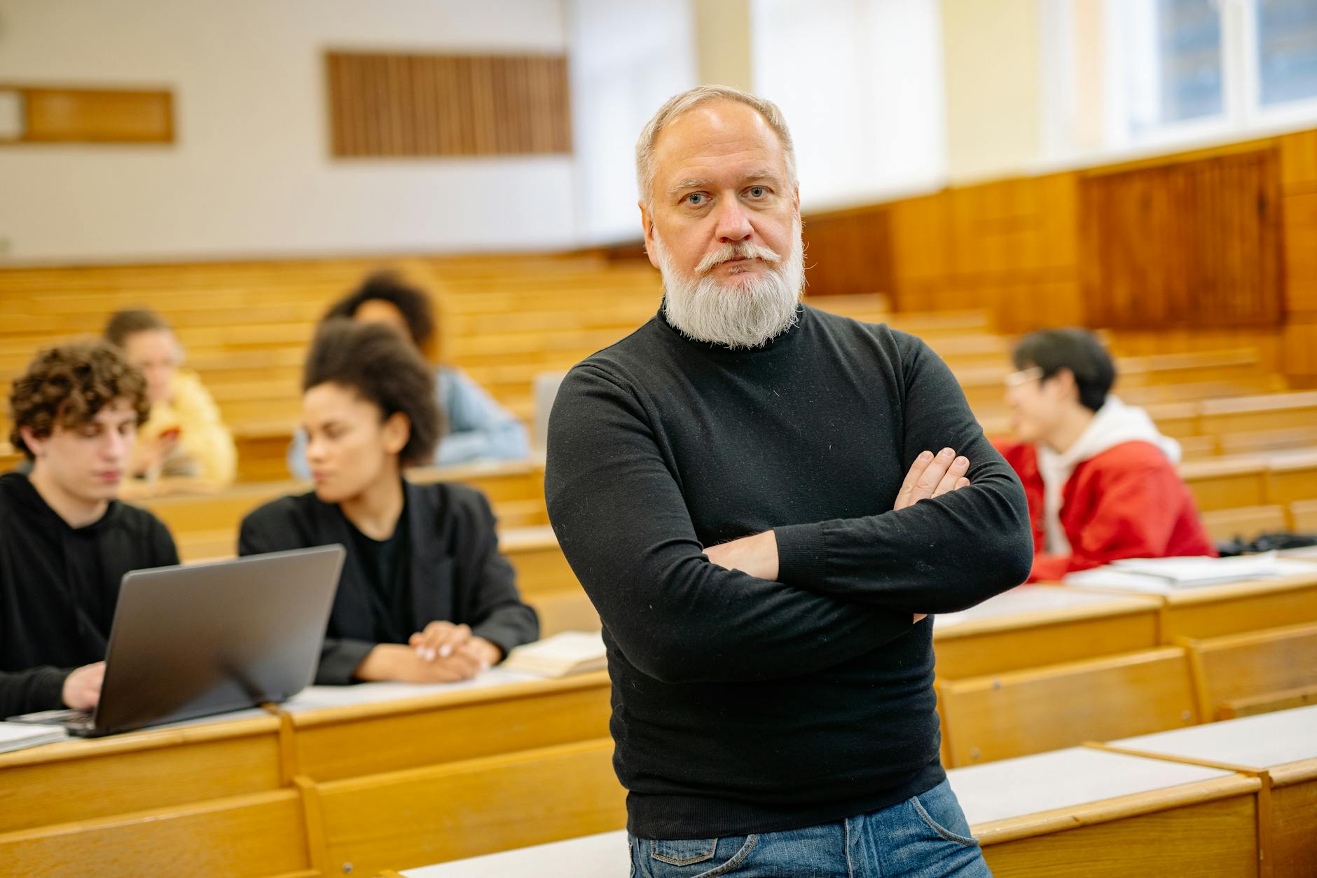 Confident professor in lecture hall with diverse students engaged in learning