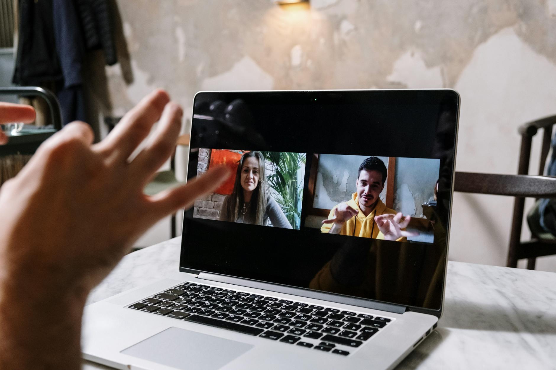 A customer success engineer on a video call walking a customer through a dashboard